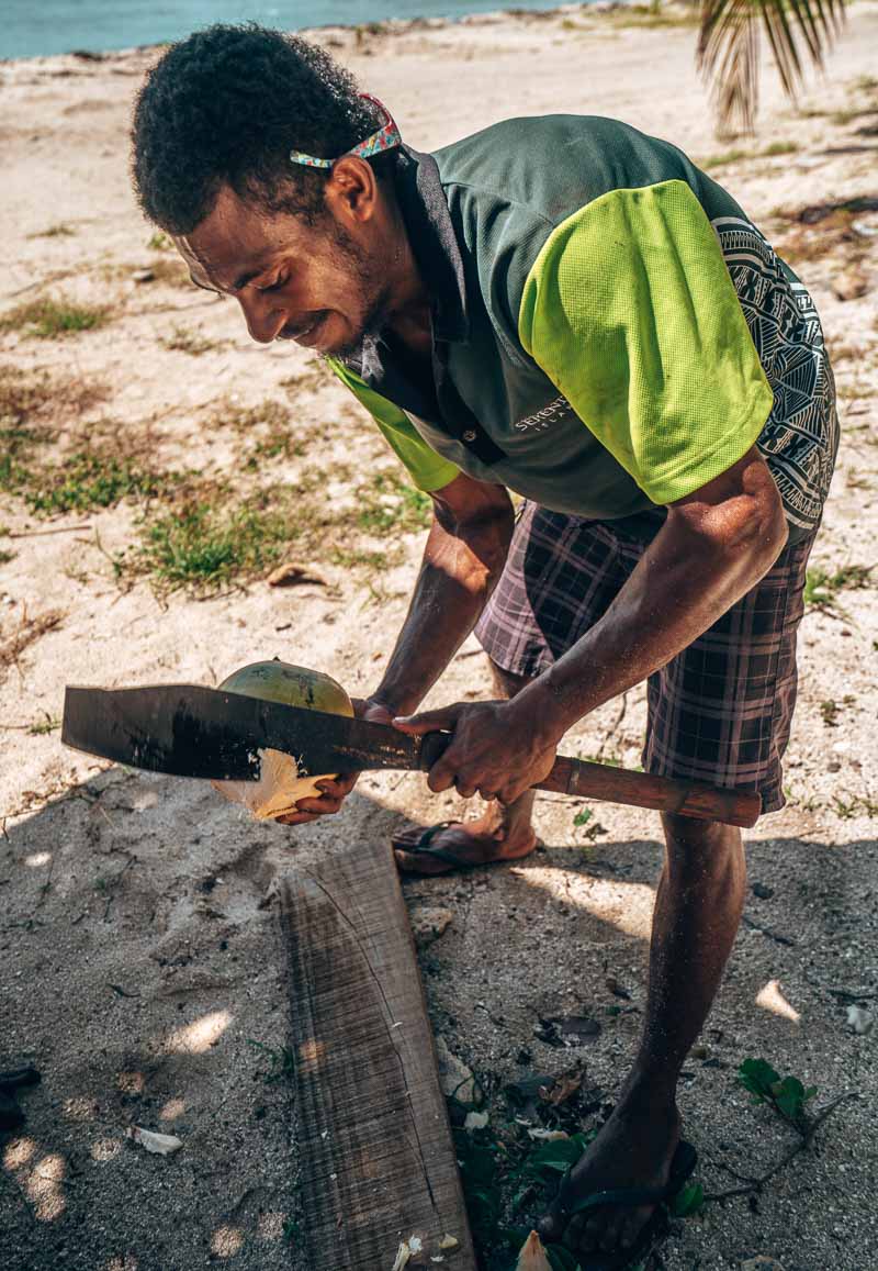 misa cutting coconuts at serenity island fiji