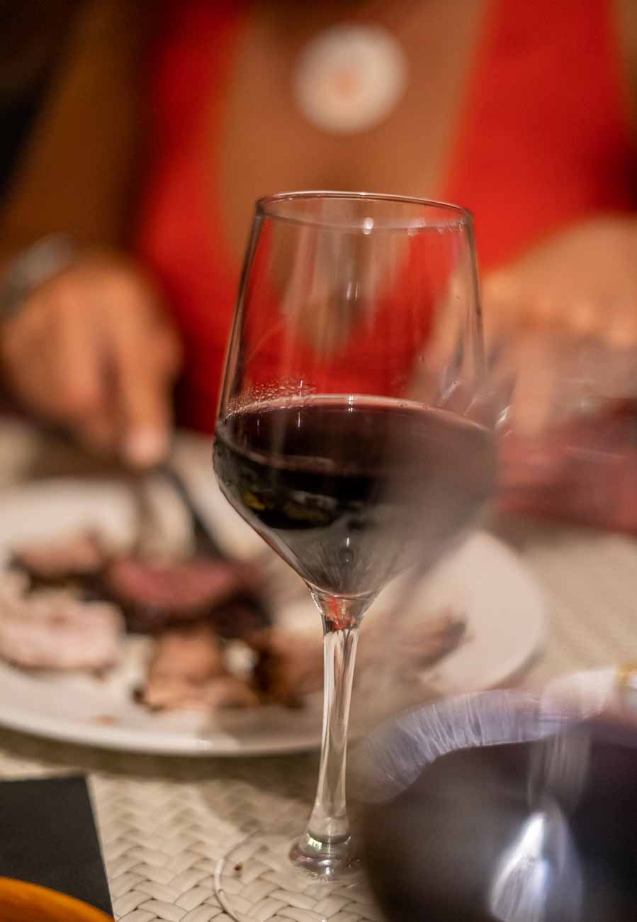 red wine glass with blurred woman